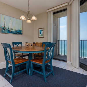 Gather around the colorful dining area for a savory meal with a beachfront view