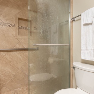 Experience a refreshing shower in the stylish master bath, complemented by elegant tile and modern fixtures