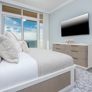 Relax on the soft king bed and unwind with your favorite show and gulf views visible through the balcony doors