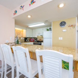 Gather around the bar-style seating, sipping drinks and sharing laughter as you enjoy time together in the kitchen space