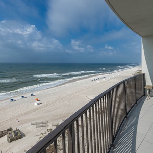 Breathe in the fresh air while relaxing on the balcony, overlooking the beach and gentle waves below