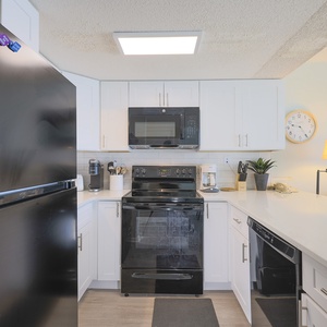 This kitchen features modern appliances, bright cabinetry, and a welcoming atmosphere perfect for meal preparation