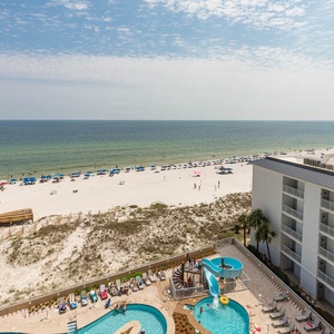 Relax by the pool and ride the waterslide, and gaze at the gulf and umbrellas on the shore