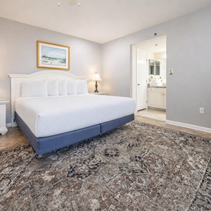 Master bedroom featuring a plush king bed, elegant decor, and an ensuite bathroom for added convenience