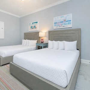 Experience restful nights in this cheerful guest room with two queen beds, beach decor, and fluffy pillows