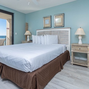 Unwind in the inviting master bedroom featuring a king bed, stylish decor, and beachfront balcony access