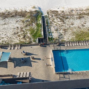 Take a dip in the inviting pool, surrounded by lounge chairs and easy access to the beach just steps away