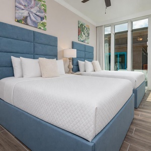 Lie back on soft pillows in this queen guest suite and watch the gulf through the floor-to-ceiling windows