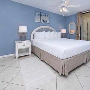 Bright and airy master bedroom featuring a plush king bed and stunning views from the balcony, perfect for a relaxing getaway