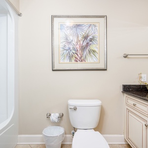 Rejuvenate in this serene guest bath, enjoying the refreshing shower after a day at the beach