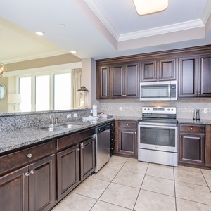 Prepare meals in this kitchen with elegant cabinetry, stainless appliances, and stylish backsplash