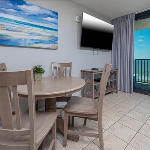 Dine at the round table while enjoying views through large sliding doors that open to a relaxing outdoor space