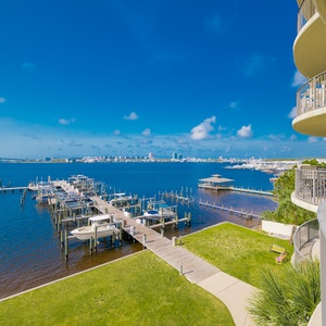Savor the gentle breeze on the balcony, taking in tranquil views of the marina and sparkling water beyond