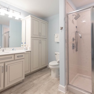 Refresh yourself with a rain shower head in this guest bath adorned with elegant cabinetry