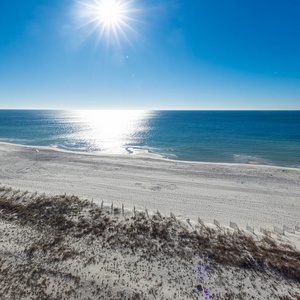 Bask in the sunlight while enjoying serene views of the shimmering water and gentle waves from your balcony