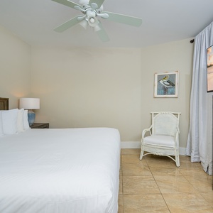 Relax in this cozy guest bedroom featuring a plush king bed, a flat-screen TV, and charming coastal decor