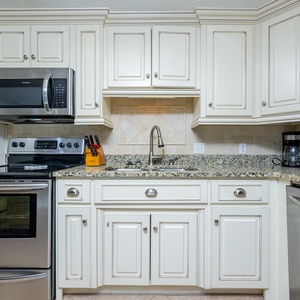 Cook and enjoy meals in this kitchen featuring granite countertops, stainless appliances, and stylish cabinetry