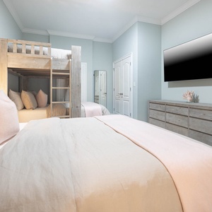 Settle in the fluffy queen and stream your favorite shows with guests cozy in the twin over queen bunk in this guest room