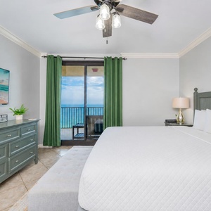 Retreat to the king master suite with cozy bedding and drift off to the sound of the waves from the balcony