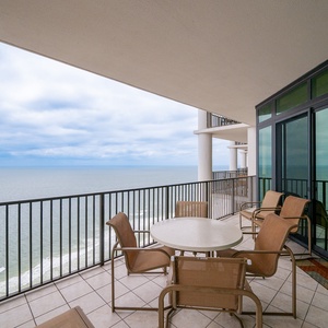 Enjoy relaxing views from the spacious balcony, featuring a round table and comfortable seating for relaxation