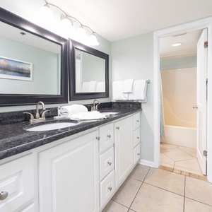Refreshing master bath with dual sinks, elegant mirrors, and a relaxing tub-shower for your comfort
