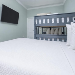 Lie back on the pillowy queen bed, watch your favorite shows on the wall TV, or claim the sturdy double bunk