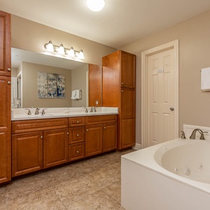 Refresh in the master bath after a day at the beach with a soothing jetted tub and relaxing walk-in shower