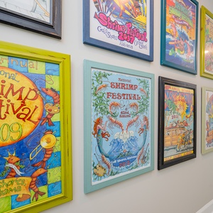 Admire the vibrant artwork celebrating local festivals, adding a lively touch to the hallway's inviting atmosphere