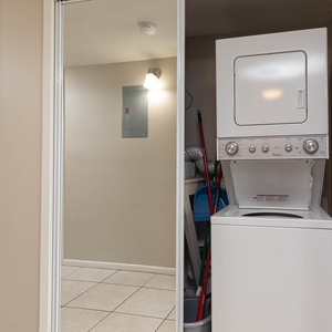 This laundry area features a stacked washer and dryer, providing convenience for guests during their stay