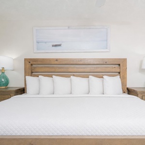 Drift into relaxation on the plush king bed, surrounded by soothing decor, ready to recharge for your coastal adventures
