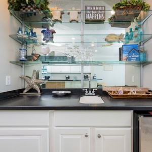 Sip a refreshing drink from your wet bar, surrounded by decor that enhances your beach vacation
