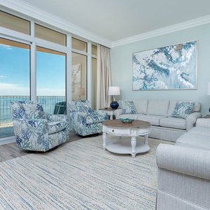 Indulge in comfort in this living space, featuring cozy seating, a sofa with queen sleeper, and stunning beach views