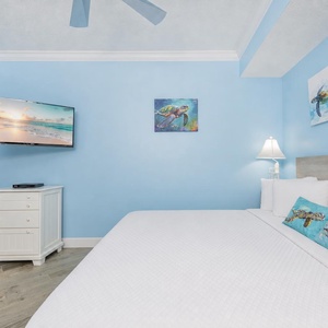 Relax on the cozy king bed in this guest suite and stream your favorite shows with cheerful turtle decor