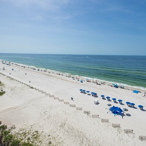 Take in the beautiful beach view with colorful umbrellas and lounge chairs, perfect for a relaxing day by the water