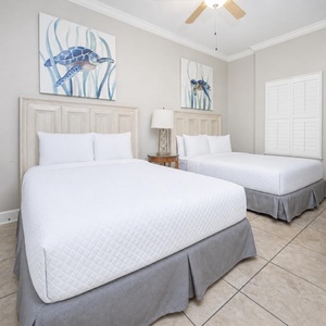 Rest in one of the queen beds, enjoying the fun turtle artwork that brings a touch of coastal charm to your retreat
