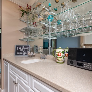 Savor refreshing drinks from the sleek wet bar while enjoying captivating views of the coast