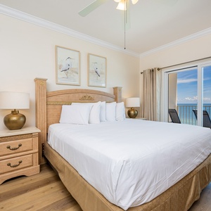 This bedroom features a king bed, elegant decor, and a stunning beachfront view from the sliding glass doors
