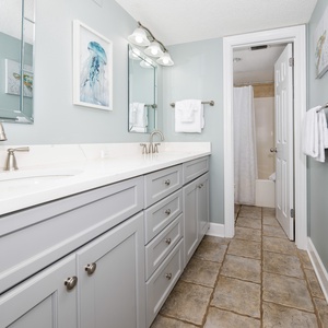 Master bathroom featuring a spacious vanity with dual sinks, modern fixtures, and a tub/shower combo