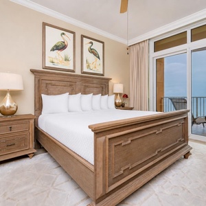 Retreat to the king master suite with cozy bedding and drift off to the sound of the waves from the balcony
