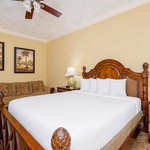 Relax on the plush queen bed in this guest room, where soft linens invite restful sleep and cozy vibes await