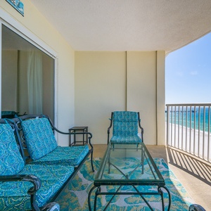 The spacious balcony features a stunning beachfront view, perfect for relaxation and enjoying the serene atmosphere
