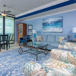 Relax in the inviting living area with plush seating, vibrant decor, and large windows offering beautiful views