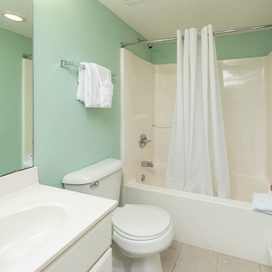 Refresh in the full bathroom featuring a spacious vanity, soft towels, and a tub-shower combo