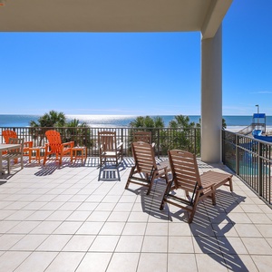 The inviting balcony features colorful seating over the lazy river, perfect for enjoying the beach view from the second floor