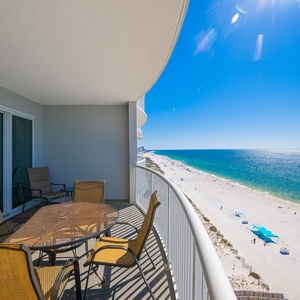 Sunlight sparkles on the gulf as you gaze out from your balcony over the vibrant beach below