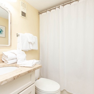 This bathroom features a stylish sink area with elegant stone countertops and fresh towels for a refreshing experience