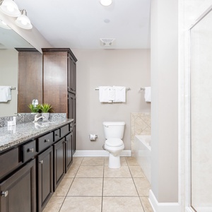 Refresh in the master bath after a day at the beach with a soothing jetted tub and relaxing walk-in shower