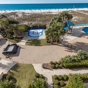 Unwind by the pool, surrounded by palm trees, while the soothing sounds of the beach create a perfect vibe