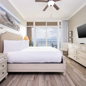 Feel the serene ambiance in the cozy master suite, where natural light highlights plush bedding and coastal views await