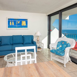 This inviting living room features a stunning beachfront view, perfect for relaxation and enjoying the scenery